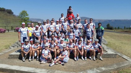The cyclists at the memorial at the top of the Long Tom Pass.