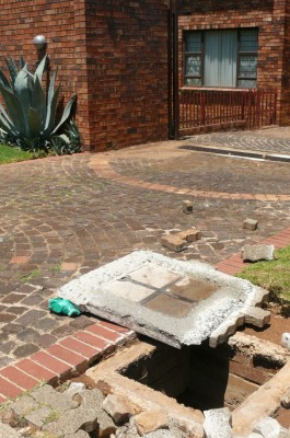 The massive amount of water forced the top of the cemented storm water drain.