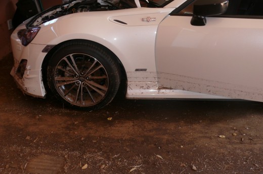 The damaged vehicle in the garage.