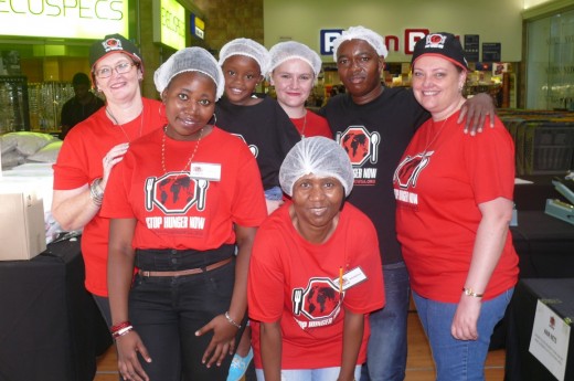 Stop Hunger Now volunteers, front: Adolphina Bokaba. Back: Dawn Troskie, Tania Bokaba, Imani Dube, Shekaila Troskie, Ntuthuko Dube and Louise Els.