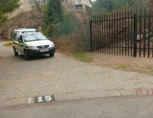 A police vehicle leaves the murder scene.