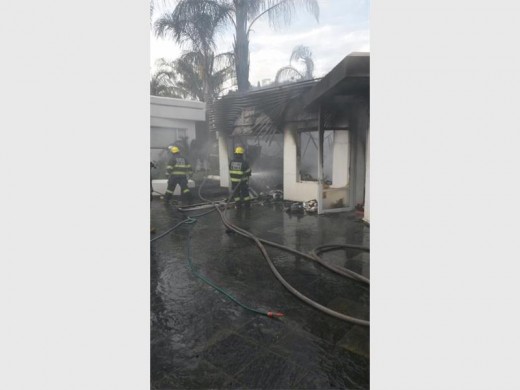 HOSING DOWN: Fire fighters hosed down the flames.